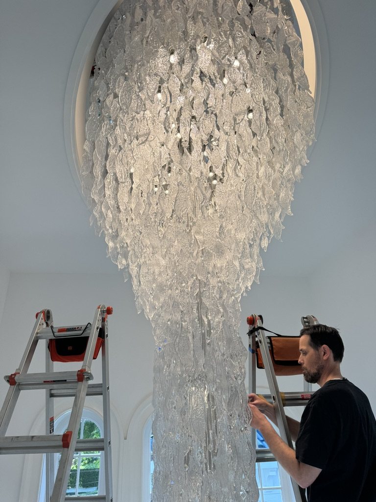 Hand-cleaning a Murano glass cascade