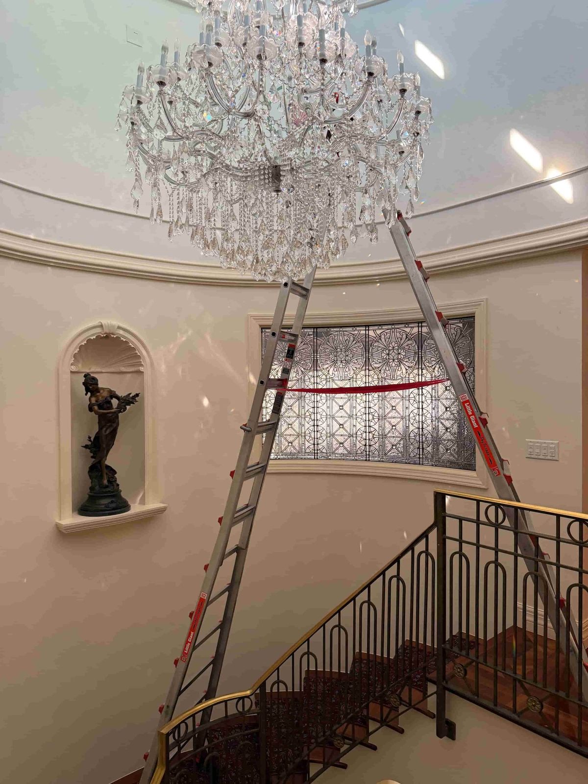 Two-story cascading crystal staircase chandelier cleaned by Brightmen, Florida